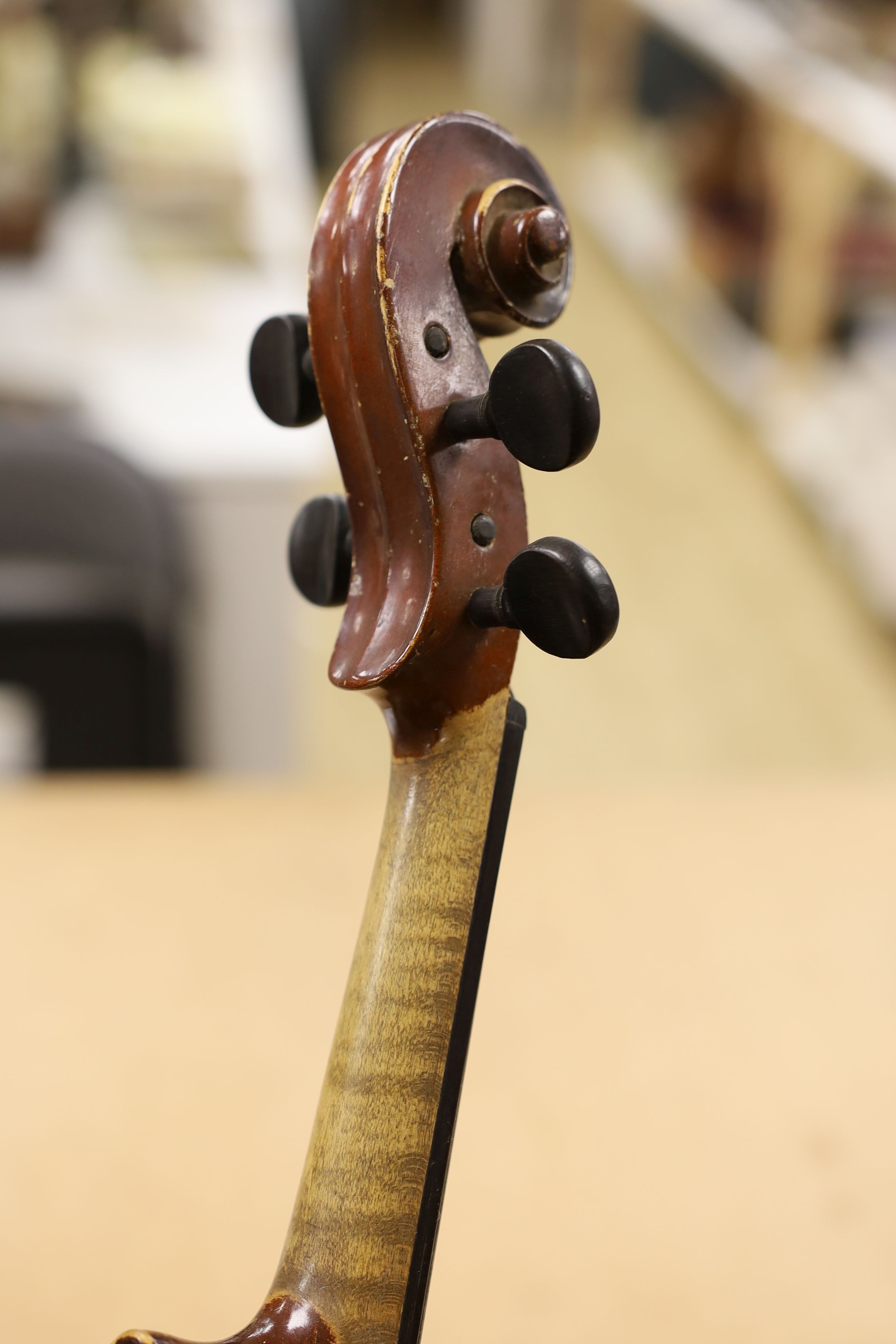 A cased violin, with bow